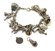 A silver charm bracelet with various charms upon, total weight 54g.