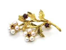 A 9ct gold floral brooch, pearl petals with garnet centres, hallmarked 375, approx 3.
