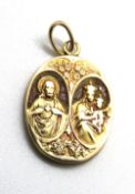 A yellow metal and goldstone pendant having Religious iconography upon, no apparent hallmarks, 2.