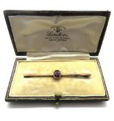 A 9ct gold and ruby Edwardian bar brooch, stamped 9ct, weighing 3g, in vintage box.