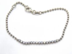A silver and white stone bracelet, stamped 925.