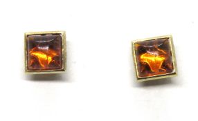 A pair of amber stud earrings, yellow metal no hallmarks,