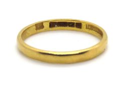 A 22ct gold D shaped band, hallmarked with makers mark Bravingtons, size J, 1.9g.