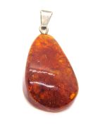 An amber pendant having 925 silver bale, approx 4.5cm total length.