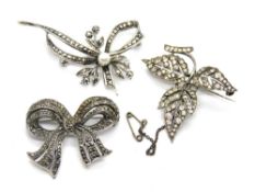 Two silver and marcasite brooches, with another similar set with white stones. Three items.