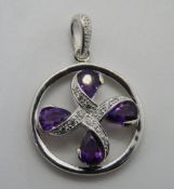 A white metal and purple stone pendant, no apparent hallmarks, 30mm in length.