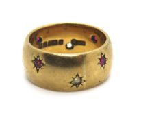 A 9ct gold ring with rubies and white stones in star settings throughout, hallmarked 375, size L, 7.