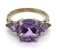 A silver and purple stone cocktail ring, size K.