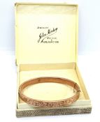 An early 20th century 9ct rose gold bangle, hallmarked for Chester 1919-20,