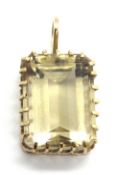 A large and impressive 9ct gold citrine pendant, the emerald cut citrine measuring approx 19 x 14mm,