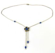 A Native American style silver beaded necklace having blue stone set floral design, marked Sterling.