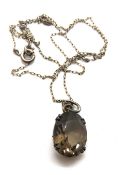 To match above lot; a smoky quartz pendant set in sterling silver with silver chain.