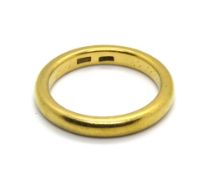 A 22ct gold D shaped band, stamped 22ct, worn engraving within, size O, 7.1g.