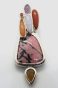 A large silver pendant set with various hardstones, 56mm in length.