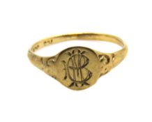 A yellow metal signet ring 'BM', indistinct marks, size E, 0.6g.