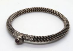 A heavy hand made bangle, no apparent hallmarks.