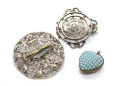 Two vintage brooches and a turquoise encrusted heart pendant.