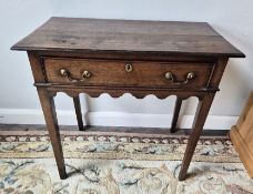 An antique Georgian oak lowboy table with single drawer and brass handles Sold in absentia -