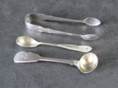 A pair of hallmarked silver sugar tongs, together with a hallmarked silver condiment spoon.