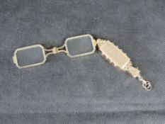 A delightful pair of folding lorgnettes.