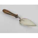 A silver plated masonic trowel having turned wooden handle, 14cm in length.