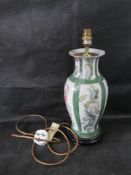 A green and white Chinese style vase converted for use as a lamp.