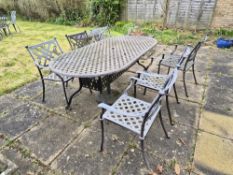 A large cast aluminium garden table with six chairs, table 213 x 104cm approx.