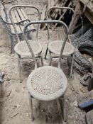 A set of three metal chairs.