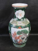 A contemporary Chinese green and white vase.