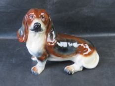 A large ceramic fireside hound figure, possibly a Beagle.