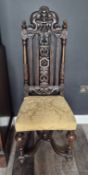 A 19th-century Victorian carved oak high back chair designed in the Carolean style,