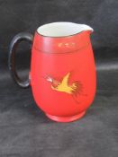 A 1920s Art Deco Shelly jug, red ground featuring cranes upon.