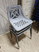 Three plastic stacking chairs.