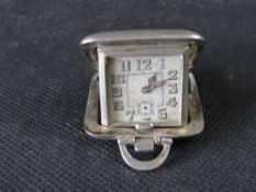 A delightful silver miniature travel clock, dial a/f.