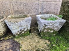 A pair of cast concrete garden pots.