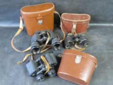 Three pairs of binoculars in cases