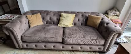 A large contemporary Chesterfield style sofa in taupe velvet, with fire labels, approx 2.6m wide.
