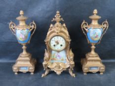 A late 19th century ormolu and porcelain mantle clock with garnitures in the style of Sevres,