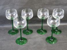 A set of six green stemmed hock glasses.
