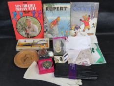 A quantity of assorted collectables including Rupert the Bear Annuals, linen handkerchiefs,