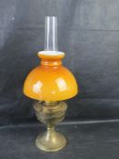 A vintage Aladdin oil lamp with amer glass shade.