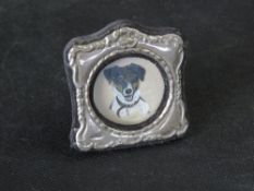 A hallmarked silver miniature photograph frame.