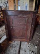 An antique hanging corner cupboard.