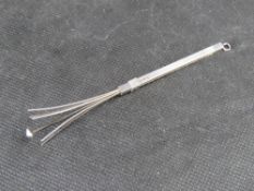 A hallmarked silver swizzle stick.