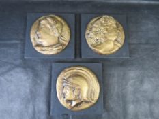 Three 'Roman Coin' decorative plaques.