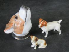 A Jack Russell figurine by Beswick, together with a stirrup cup dogs head and another figurine.