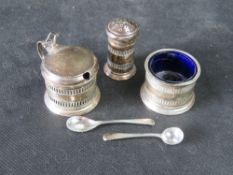 A hallmarked silver cruet set having Bristol blue glass liners, total weight 136.6g.
