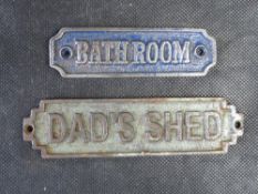 Two contemporary cast iron room signs.
