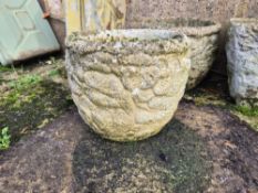 A pair of cast concrete garden pots.