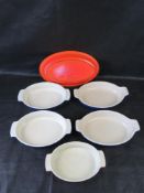 A quantity of Le Creuset dishes.